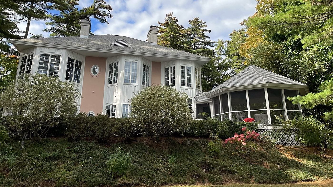 Large residence with a new roof under a blue sky
