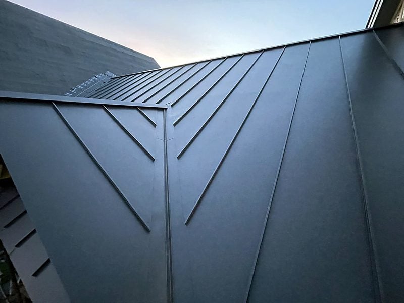 Close-up of dark standing seam metal panels